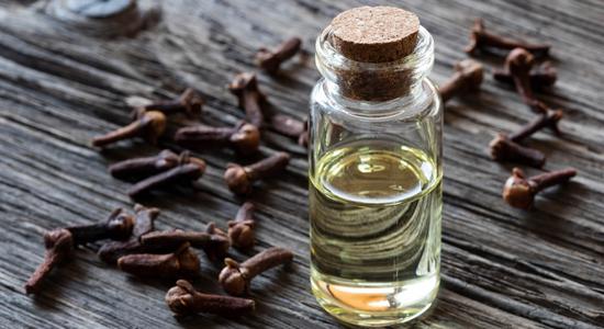 Clove essential oil is mainly comprised of the chemical eugenol.  Eugenol is a natural pain releiver. Clove oil is often used to reduce the pain of toothaches; and, using it orally helps to allay the growth bacterial pathogens.